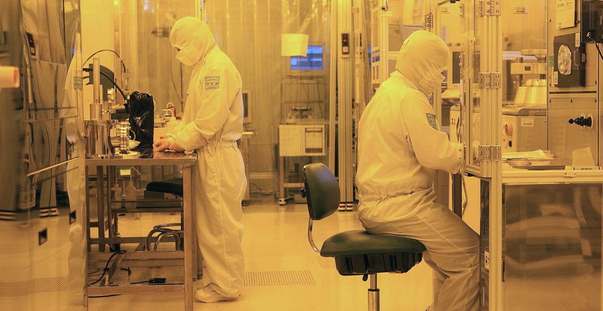 Screen image of two researchers working in a dust-proof garment